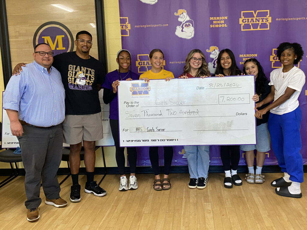photo - MHS girls soccer team gathers to receive a donation from MHSAA on 8/25/26