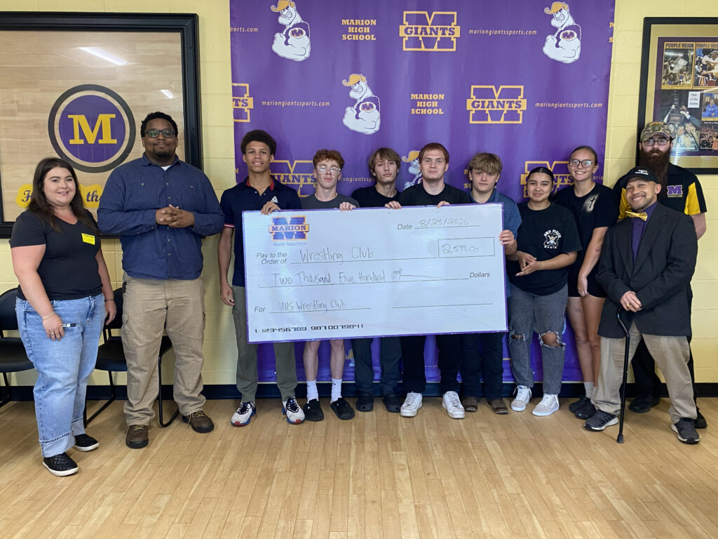 photo - MHS wrestling team gathers to receive a donation from MHSAA on 8/25/26